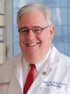 A man in white lab coat and red tie.