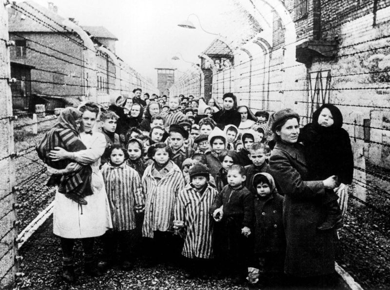 A group of people standing in the street.