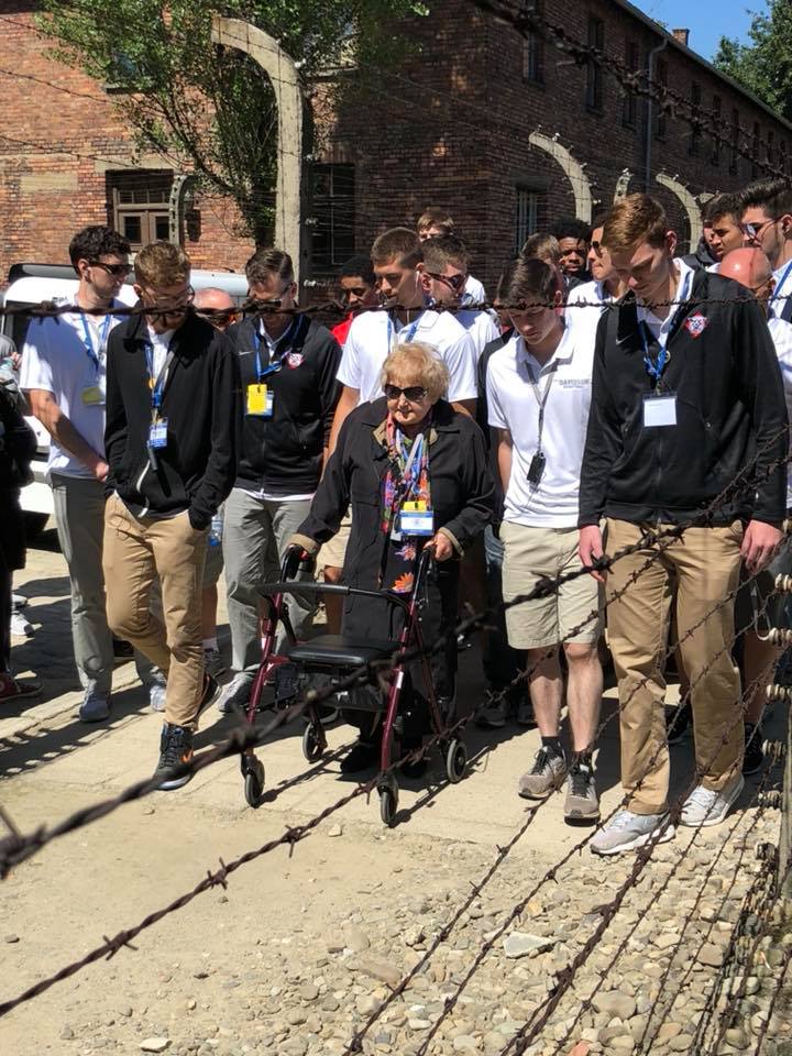 A group of people standing around an elderly woman.